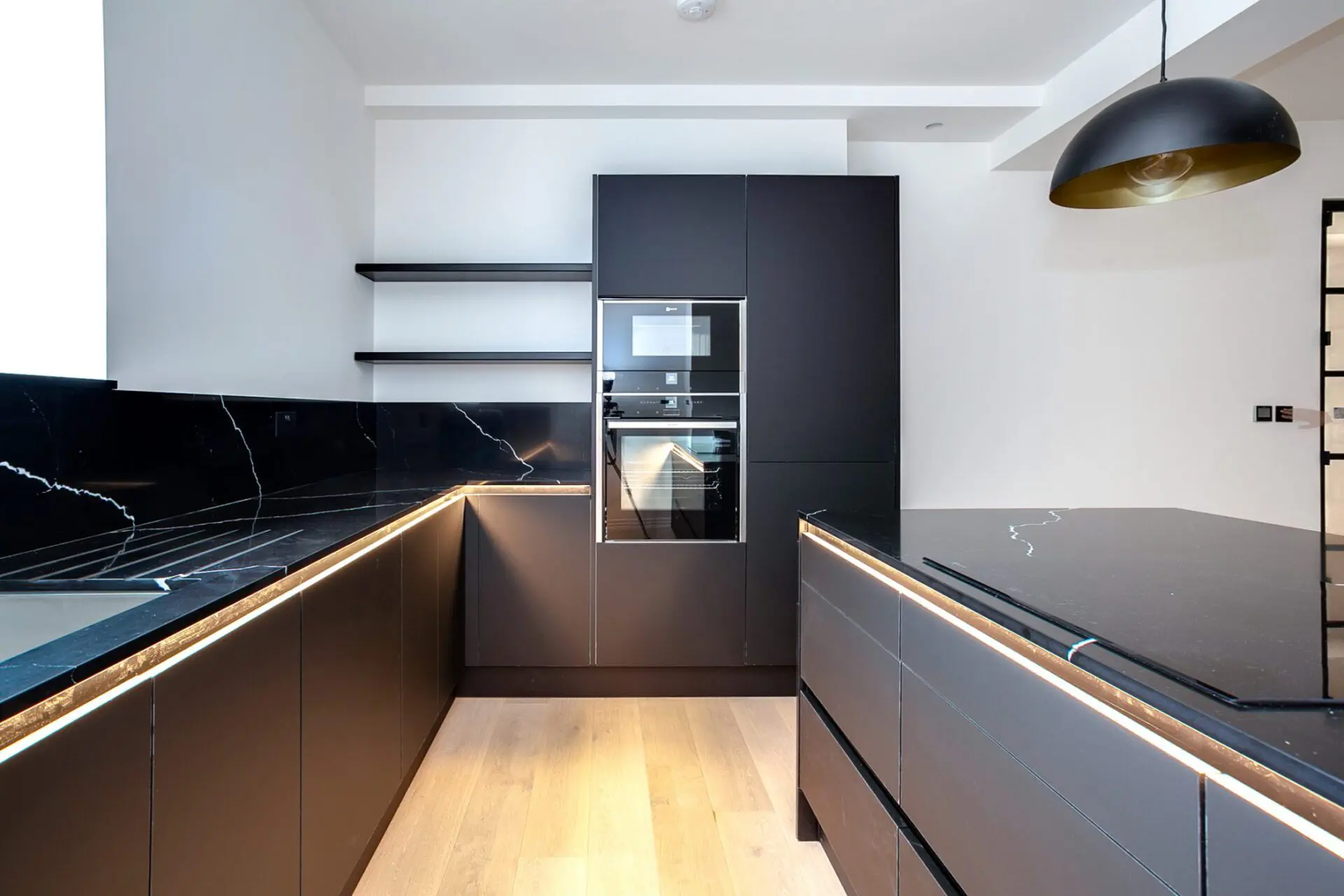 Bauhaus Kitchen With Waterfall Stone Worktop And Vertical Grain Cabinetry Showcasing Clean Architectural Lines