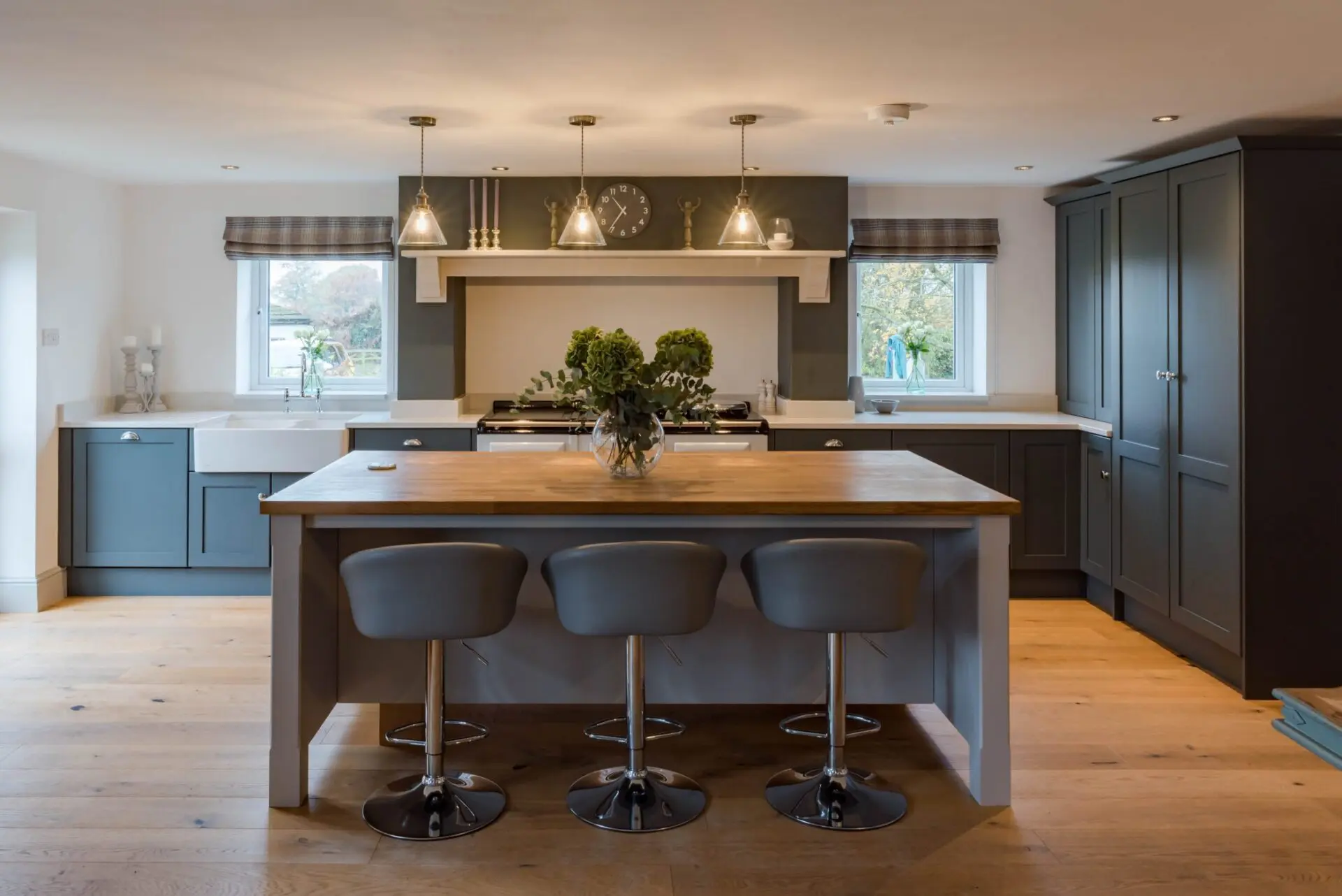 Bespoke Shaker Kitchen With Breakfast Bar Seating And Integrated Appliances Designed For Modern Family Living