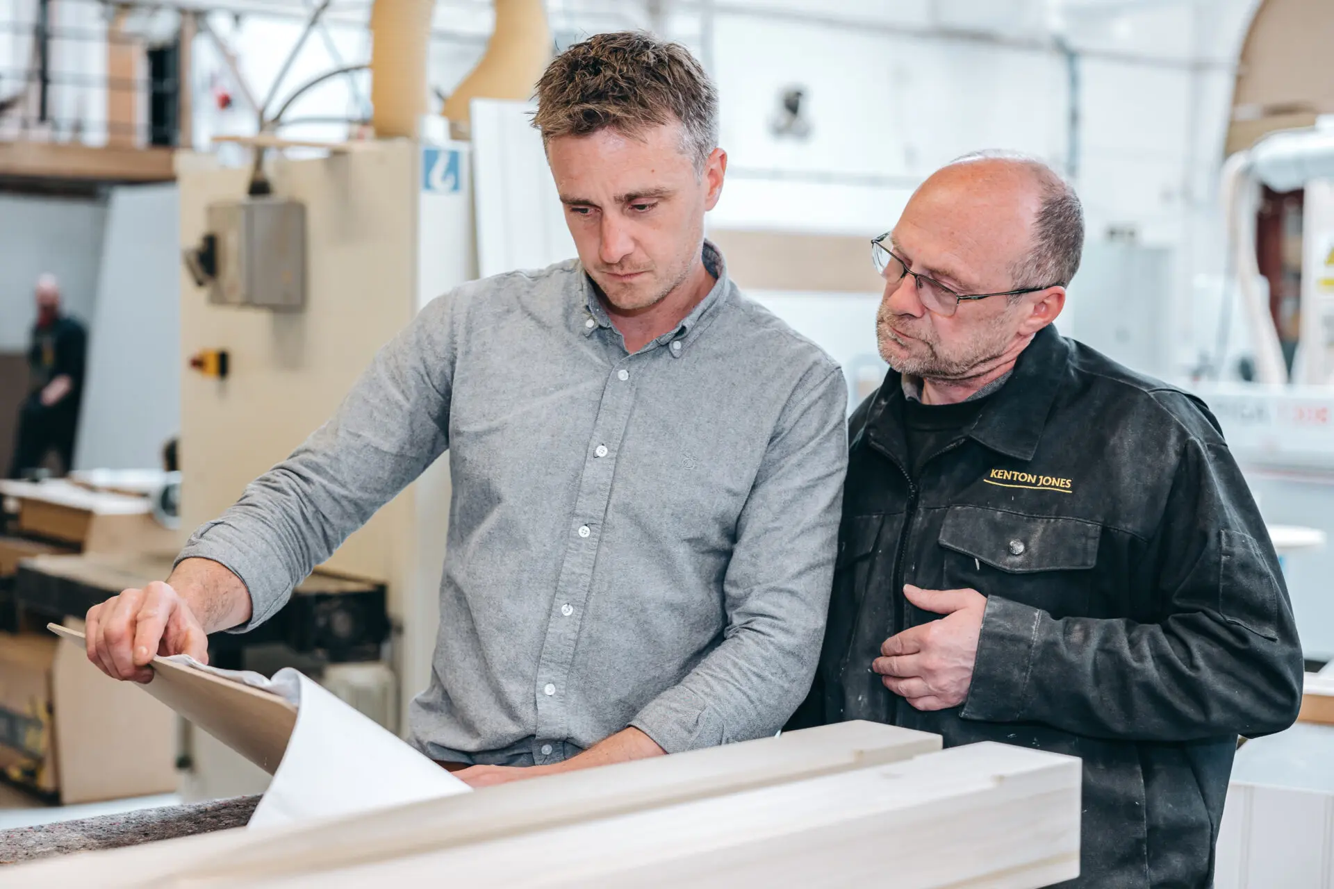 Kenton Jones And Designers Reviewing Bespoke Outdoor Kitchen Plans And Joinery Details In Workshop