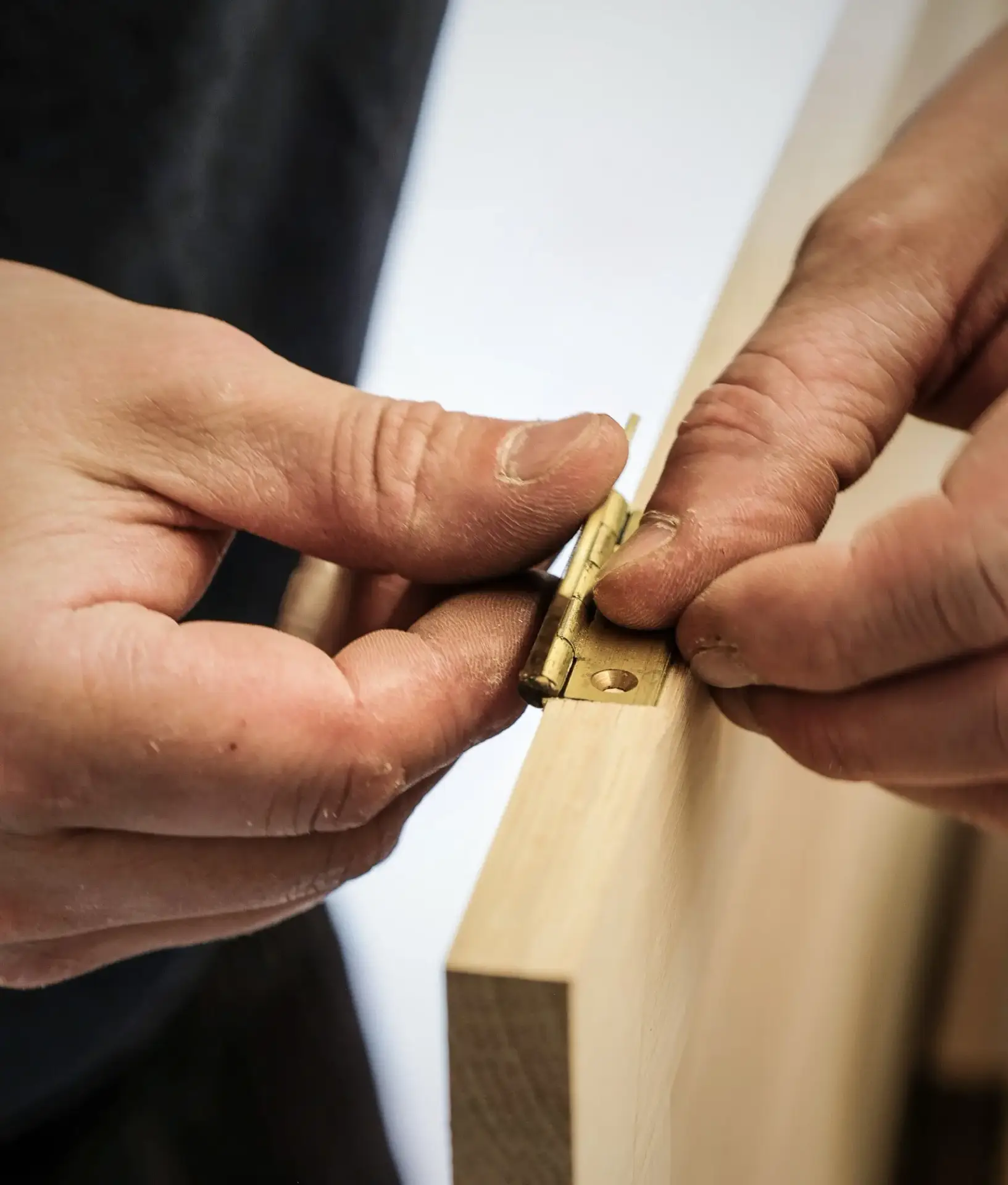 Kitchen Maker And Designer Putting Finishing Touches On Bespoke Door