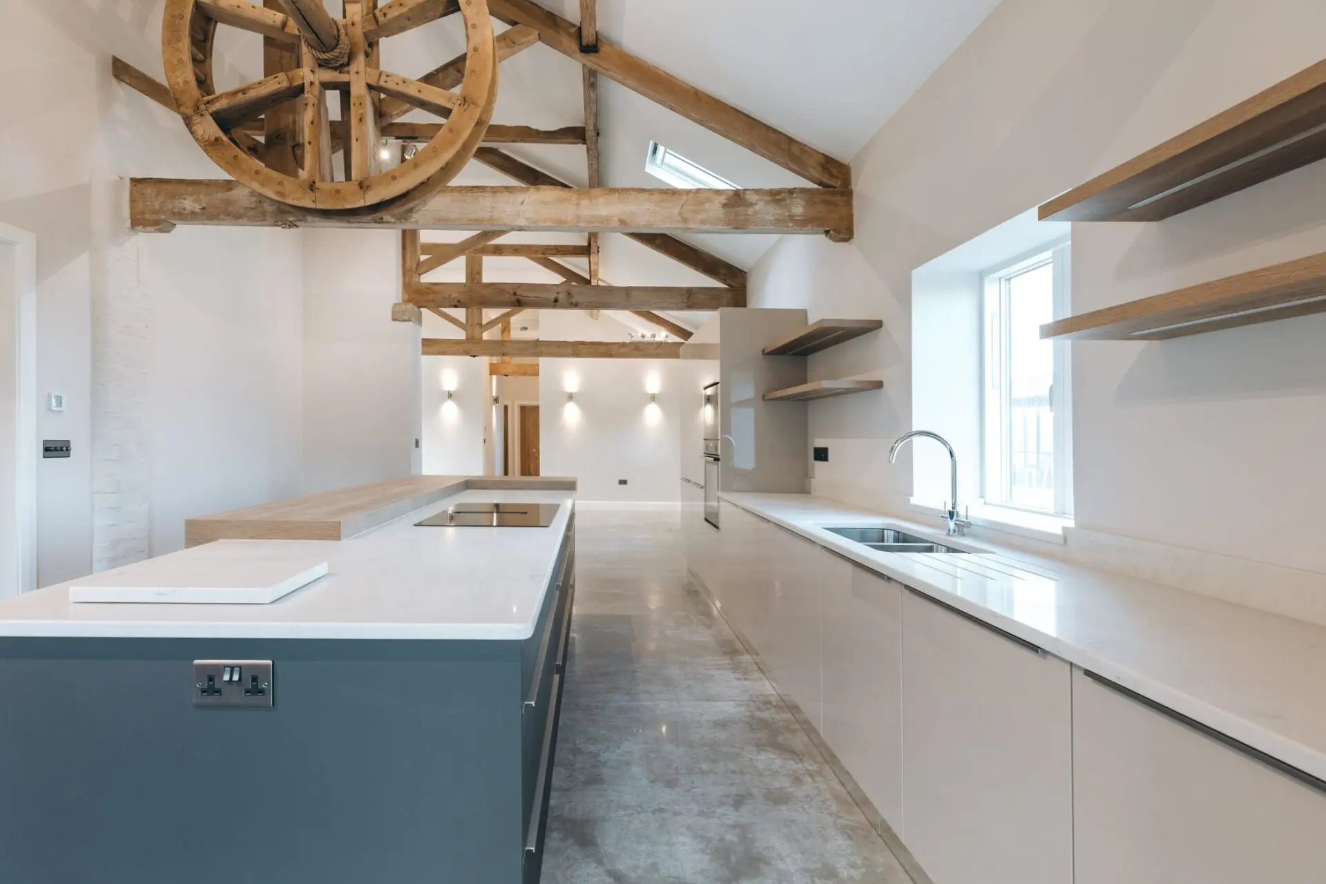 Minimalist Industrial Style Kitchen Featuring Flush Handleless Doors And Warm Wood Accents For A Balanced Modern Aesthetic