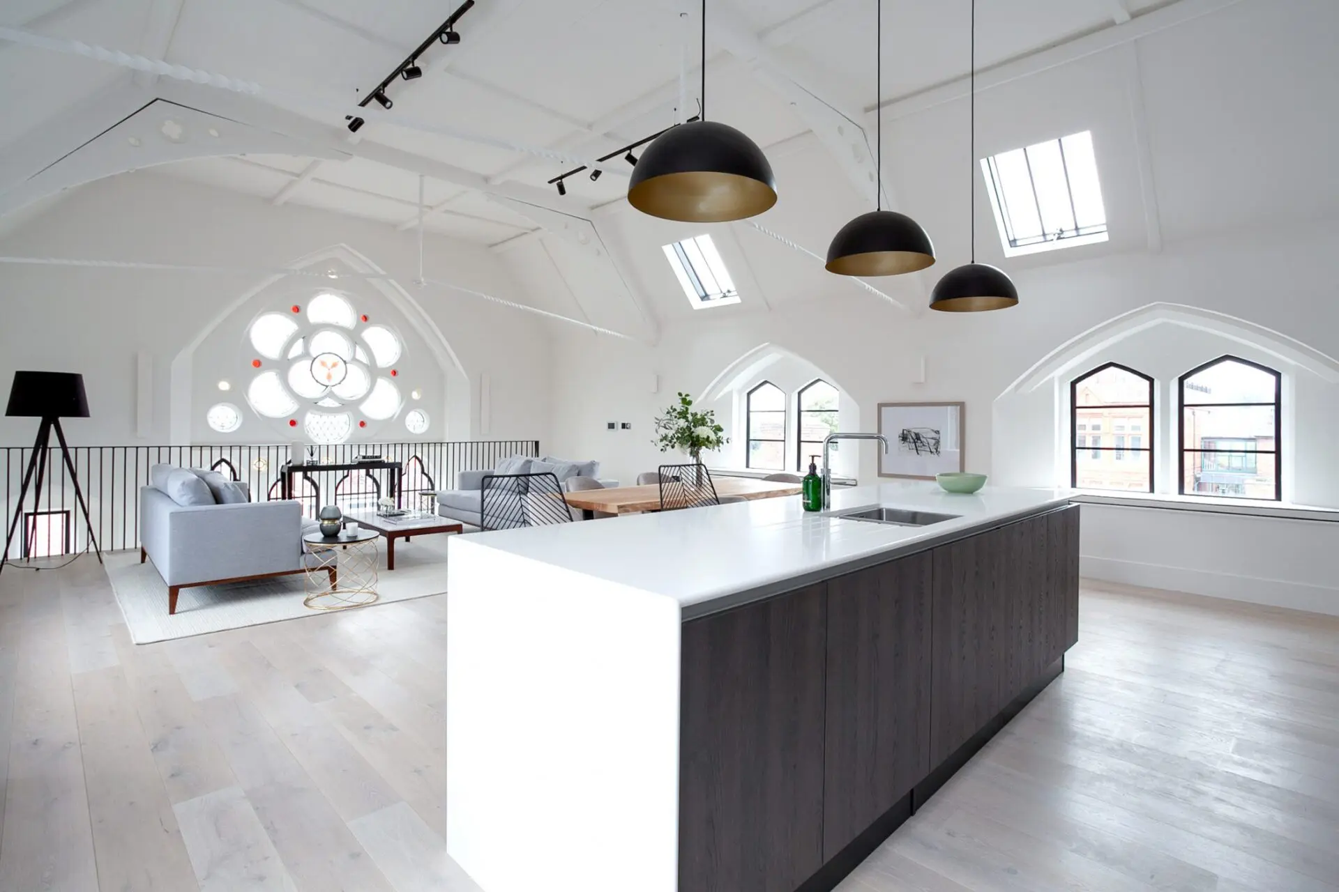 Modern Industrial Kitchen With High Ceilings Timber Flooring And Statement Lighting Balancing Raw Materials With Warmth